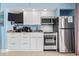 White kitchen with stainless steel appliances and granite countertops at 5308 N Ocean Blvd. # 1003, Myrtle Beach, SC 29577