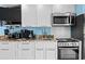 White kitchen with stainless steel appliances at 5308 N Ocean Blvd. # 1003, Myrtle Beach, SC 29577