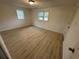Bedroom features a wood look floor and two windows for natural light at 538 Oatland Rd., Georgetown, SC 29440