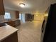 A kitchen with a view to a fireplace, dishwasher and tiled floors at 538 Oatland Rd., Georgetown, SC 29440