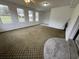 Bright living room featuring large windows for natural light and an interesting patterned carpet at 538 Oatland Rd., Georgetown, SC 29440