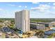 Aerial view of tall white condo building with pools near ocean and campground at 5905 S Kings Hwy. # 810-C, Myrtle Beach, SC 29575