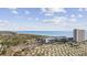 Scenic aerial view showcasing the ocean, surrounding community, RV park, and high-rise condo at 5905 S Kings Hwy. # 810-C, Myrtle Beach, SC 29575