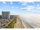 Expansive aerial view of the coastline, beach, and condo complex on sunny day at 5905 S Kings Hwy. # 810-C, Myrtle Beach, SC 29575