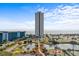 Scenic aerial view featuring a high-rise condo building, pond, parking, and partial ocean views on a partly cloudy day at 5905 S Kings Hwy. # 810-C, Myrtle Beach, SC 29575