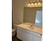 Elegant bathroom with white vanity, a large mirror, and modern lighting fixtures, perfect for a relaxing routine at 619 Castillo Dr., Loris, SC 29569