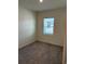 Cozy bedroom with soft carpeting, large window, and neutral paint, offering a comfortable and private retreat at 619 Castillo Dr., Loris, SC 29569