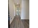 Inviting hallway with durable wood-look flooring leading to naturally lit living spaces, with crisp, neutral paint at 619 Castillo Dr., Loris, SC 29569