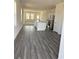 Bright open-concept living space combining modern flooring, natural light, and a stylish kitchen with stainless appliances at 619 Castillo Dr., Loris, SC 29569