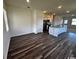 Open-concept living space features modern wood floors, a breakfast bar, and natural light, connecting the kitchen at 619 Castillo Dr., Loris, SC 29569