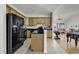 Open-concept kitchen featuring a center island, tiled flooring, and a seamless flow into the living area at 621 Cottontail Trail, Myrtle Beach, SC 29588