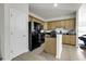 Functional kitchen featuring tan wood cabinets and dark countertops at 621 Cottontail Trail, Myrtle Beach, SC 29588