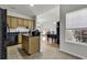 Functional kitchen featuring tan wood cabinets and dark countertops at 621 Cottontail Trail, Myrtle Beach, SC 29588