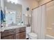 Bathroom with granite countertops, dark wood cabinets, and shower with curtain at 622 Lorenzo Dr. # 622, North Myrtle Beach, SC 29582