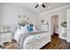 Well-lit bedroom featuring hardwood floors, panel molding, and white furniture with decorative bedding at 622 Lorenzo Dr. # 622, North Myrtle Beach, SC 29582