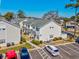 Aerial view of condos in a parking lot showing landscaping, multiple floors, and a parking lot at 701 1St Ave. S # 32C, North Myrtle Beach, SC 29582