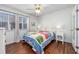 Bedroom with bright, natural light, hardwood floors, and a quilt-covered bed offers a warm and inviting space at 701 1St Ave. S # 32C, North Myrtle Beach, SC 29582