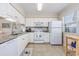 Bright kitchen features white cabinets, granite countertops, and tile flooring at 701 1St Ave. S # 32C, North Myrtle Beach, SC 29582