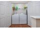 A bright laundry room with white washer and dryer units and plenty of storage shelves at 701 1St Ave. S # 32C, North Myrtle Beach, SC 29582