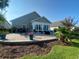 Paver patio featuring a sunroom, seating, and landscaping with privacy at 808 Yauhannah Dr., Little River, SC 29566