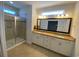 Bright bathroom boasts double sinks, granite countertops, a glass enclosed shower, and tile flooring at 808 Yauhannah Dr., Little River, SC 29566