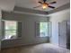 Spacious bedroom features ceiling fan and windows with plantation shutters at 808 Yauhannah Dr., Little River, SC 29566