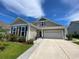 Charming home exterior with neutral siding, rocking chairs on the porch, and a two-car garage at 808 Yauhannah Dr., Little River, SC 29566