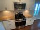 Close up of the stainless steel gas range, microwave and granite countertops at 808 Yauhannah Dr., Little River, SC 29566