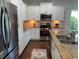 Modern kitchen featuring white cabinets, stainless steel appliances, granite countertops, and hardwood floors at 808 Yauhannah Dr., Little River, SC 29566
