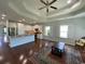 Open-concept kitchen and living area with white cabinets, granite countertops, and hardwood floors at 808 Yauhannah Dr., Little River, SC 29566