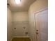 Neutral-colored laundry room with vinyl flooring includes hookups, shelving, and a door to the exterior at 808 Yauhannah Dr., Little River, SC 29566