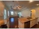 Open-concept living room with a ceiling fan, hardwood floors, and three large windows at 808 Yauhannah Dr., Little River, SC 29566