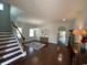 Bright and spacious living room featuring hardwood floors, staircase, and an open floor plan at 808 Yauhannah Dr., Little River, SC 29566