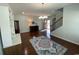 Open-concept living area with hardwood floors, staircase, and a view of the front entry at 808 Yauhannah Dr., Little River, SC 29566