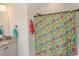 Bright bathroom featuring a vanity with granite countertop and a shower with a vibrant shower curtain at 845 Hall Lane # B, Myrtle Beach, SC 29577