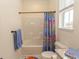 Bright bathroom features a tub-shower combination with colorful shower curtain and a window for natural light at 845 Hall Lane # B, Myrtle Beach, SC 29577