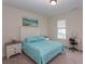 Bright bedroom featuring a queen bed, beach art, two bedside tables, and a vanity with a makeup mirror at 845 Hall Lane # B, Myrtle Beach, SC 29577