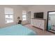 Bedroom showing queen bed, windows, dresser with TV, makeup mirror, and bedroom decor at 845 Hall Lane # B, Myrtle Beach, SC 29577