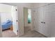 Hallway with neutral paint with view of two bedrooms with plush carpets and blue bedding at 845 Hall Lane # B, Myrtle Beach, SC 29577