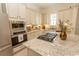 Modern kitchen with stainless steel appliances, a cooktop island, and bright, white cabinetry at 845 Hall Lane # B, Myrtle Beach, SC 29577