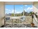 Cozy screened-in balcony with a table and chairs, offering scenic outdoor views at 901 West Port Dr. # 1611, North Myrtle Beach, SC 29582