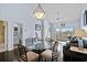 Open concept dining area with a glass-top table, seating for four, and hardwood floors at 901 West Port Dr. # 1611, North Myrtle Beach, SC 29582