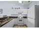 Bright kitchen with white cabinetry, modern appliances, and tile flooring at 901 West Port Dr. # 1611, North Myrtle Beach, SC 29582