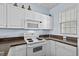 Close-up of a kitchen featuring white cabinets, dark countertops and stainless steel appliances at 901 West Port Dr. # 1611, North Myrtle Beach, SC 29582