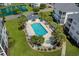 Aerial view of a refreshing pool area with lounge chairs, lush landscaping, and a pristine jacuzzi at 901 West Port Dr. # 1611, North Myrtle Beach, SC 29582