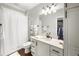 Cozy bathroom featuring a shower with curtain and a vanity with a cream colored countertop and storage at 915 Preservation Circle, Pawleys Island, SC 29585
