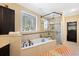 Luxurious bathroom features a soaking tub, a separate glass-enclosed shower, and elegant fixtures at 915 Preservation Circle, Pawleys Island, SC 29585