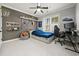 This cozy bedroom is complete with carpeted floors, a ceiling fan and plenty of natural light at 915 Preservation Circle, Pawleys Island, SC 29585
