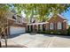 Beautiful brick home featuring an attached garage, manicured landscaping and charming front porch with columns at 915 Preservation Circle, Pawleys Island, SC 29585