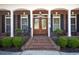 Charming front porch with brick steps, black shutters, double doors and well maintained landscaping at 915 Preservation Circle, Pawleys Island, SC 29585
